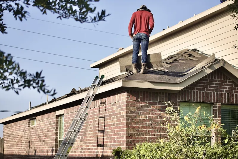 Professional roofer working on a residential roof in Sansom Park